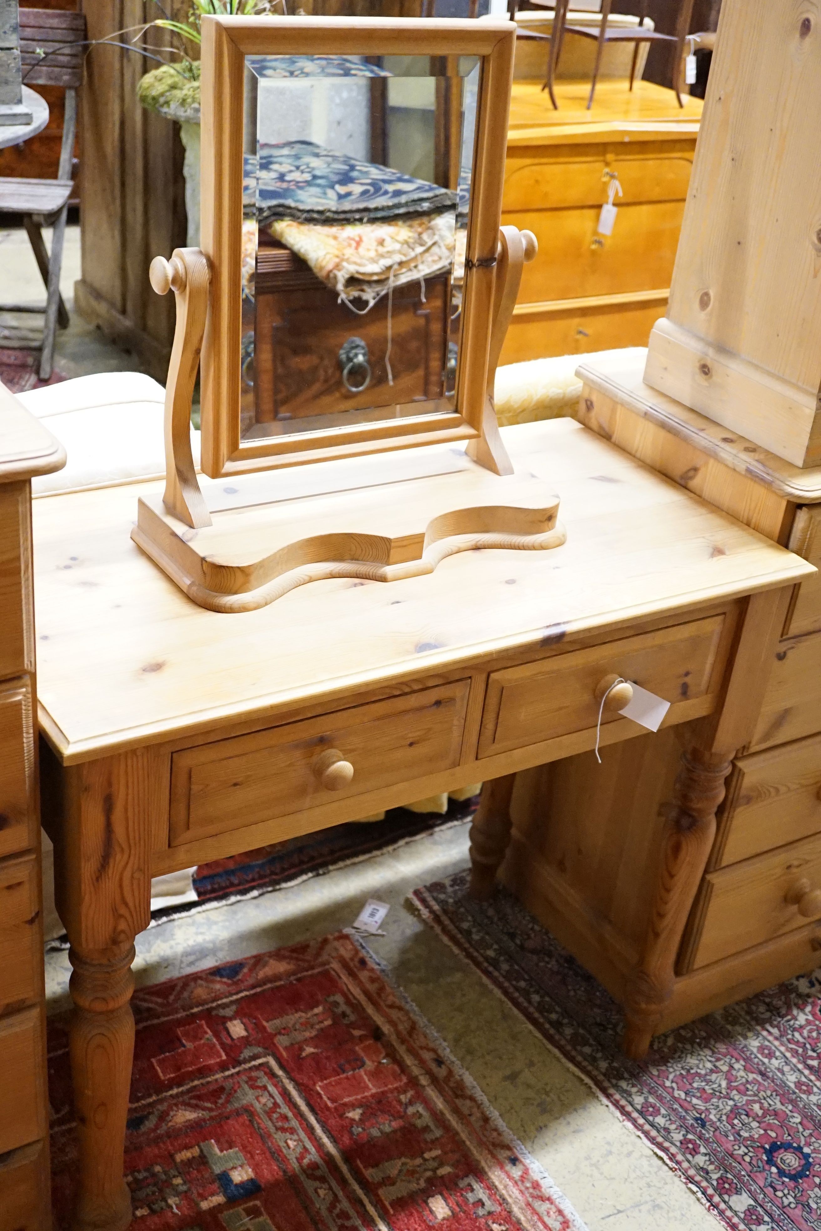 A pine side table, 89cm, a low cabinet, two chests of drawers, a pair of bedside tables, a mirror and jewellery box (8)